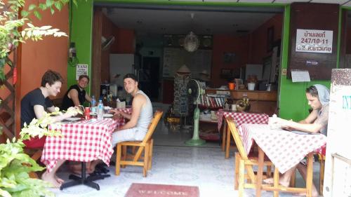 a group of people sitting at tables in a restaurant at Seaworld Guesthouse in Ao Nang Beach