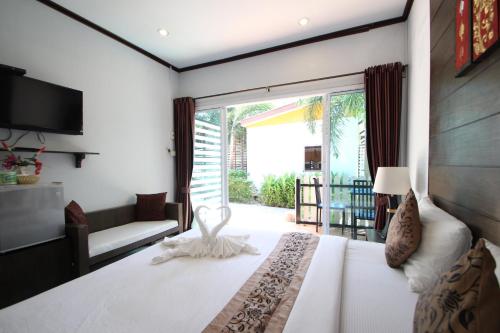a bedroom with a large bed and a large window at KK Lipe Resort in Ko Lipe