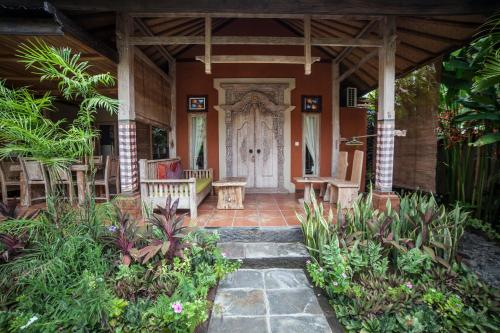 a front porch of a house with a white door at Global Royal Pemuteran in Pemuteran