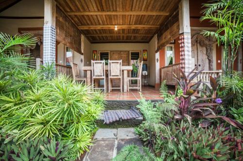 a porch with chairs and plants on a house at Global Royal Pemuteran in Pemuteran