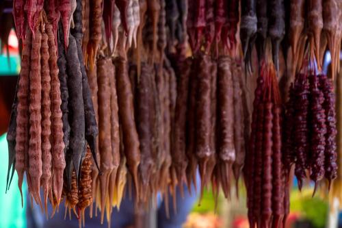 a bunch of sausage hanging in a market at Chateau Napareuli in Napareuli