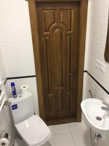 a bathroom with a toilet and a sink at Polyana Apart in Polyana