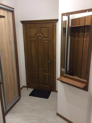 a room with a closet and a wooden door at Polyana Apart in Polyana