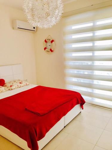 a bedroom with a red blanket on a bed at VILLA 16L in Kalecik