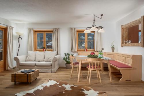 a living room with a table and a couch at Buccara Apartments Kitzbühel in Kitzbühel