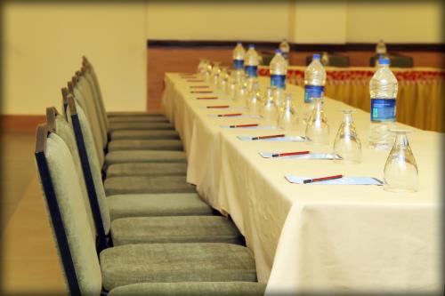 a row of tables with bottles of water on them at Dhawala Resort By Aamod in Alwar