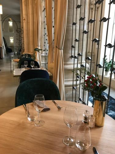 two wine glasses sitting on a table in a restaurant at Mercure Poitiers Centre in Poitiers