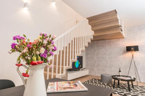 a living room with a vase with flowers on a table at Luxury Suites Liechtenstein in Vienna