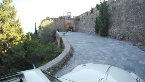 a car parked on a road next to a wall at stunning tranquil villa with private pool in Sami