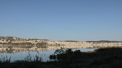 a large body of water with a city in the background at stunning tranquil villa with private pool in Sami