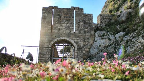 an old stone building with a gate on a mountain at stunning tranquil villa with private pool in Sami