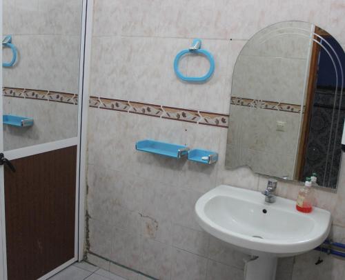 a bathroom with a sink and a mirror at Hotel Souika in Chefchaouen