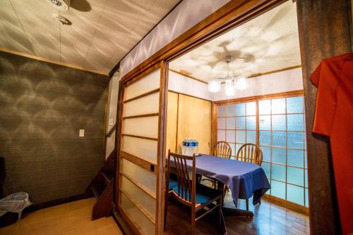 a dining room with a table and a window at Kumano House in Kyoto
