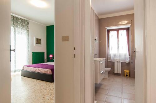 a bedroom with a bed and a bathroom with a sink at Casa Cariddi in Sperlonga