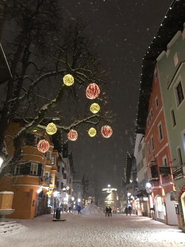 a city street with christmas lights hanging from a tree at Kössen DORF41 TOP2 in Kössen