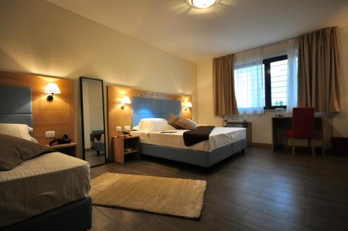 Postel nebo postele na pokoji v ubytování Hotel 325 Tor Vergata
