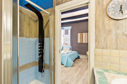 a bathroom with a shower and a bed in a room at Rome As You Feel - Design Apartment at Colosseum in Rome