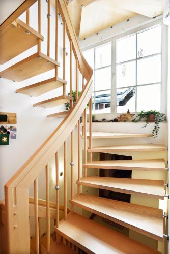 a wooden staircase in a house with a window at Landhaus Mooslechner in Radstadt