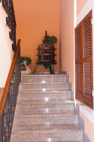 a staircase in a house with a wooden door at Montanari Agrivillage in Narni