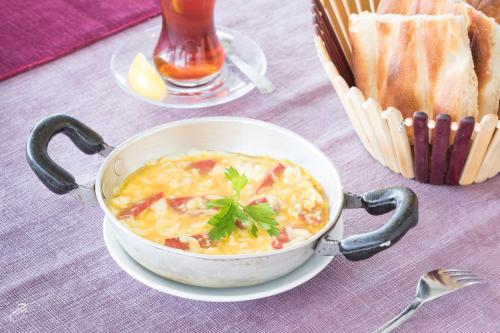 a bowl of soup on a table with a basket of bread at Hotel Dosco in Van