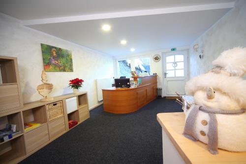 an office with a large stuffed animal sitting on a desk at Vila Edelweiss Rooms&App Kranjska Gora in Kranjska Gora