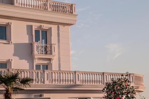 a balcony on the side of a building with a plant at Hotel Villa Pascucci in Durrës
