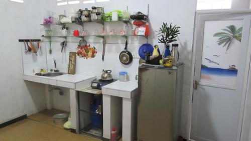 a kitchen with a sink and a refrigerator at City Bay House in Weligama