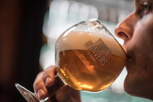 a man drinking a glass of beer at ibis Antwerpen Centrum in Antwerp