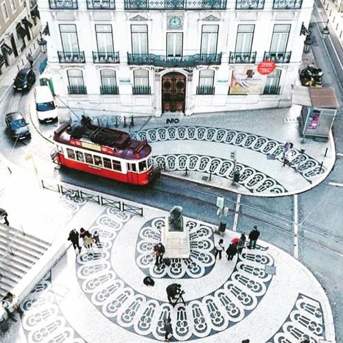 a red trolley is parked in front of a building at Apartments Alfacinha Ajuda in Lisbon