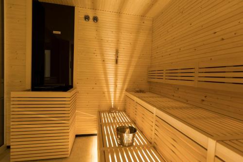 a sauna with two benches in a wooden room at The Ischgl Lodge in Ischgl