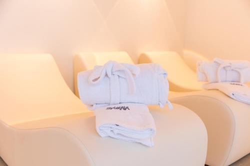 a pile of towels sitting on top of a chair at The Ischgl Lodge in Ischgl
