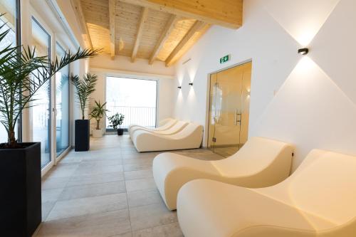 a lobby with white furniture and a large window at The Ischgl Lodge in Ischgl