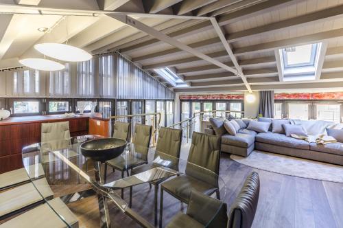 a living room with a couch and a table and chairs at Luxury Penthouse Venice in Venice