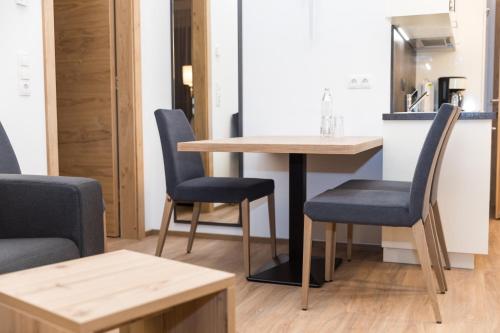 a table and chairs in a room with a kitchen at The Ischgl Lodge in Ischgl
