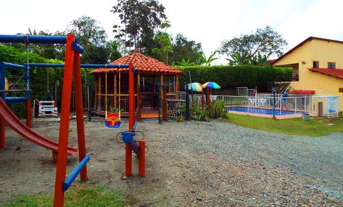 a park with a playground with a swing set at Hotel Campestre Alto Bonito del Quindío in El Cuzco
