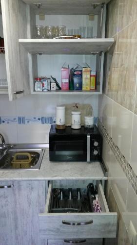 a small kitchen with a sink and a stove at Le Petit in Tbilisi City