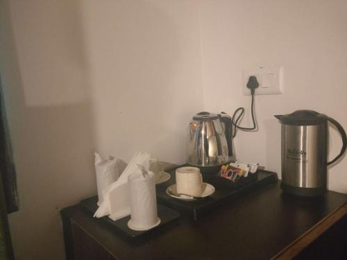 a counter with a coffee pot and paper towels at Nainital Adventure Park & Resort in Nainital