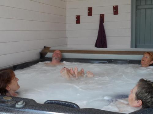 a group of people in a jacuzzi tub at Chambre d'Hôtes Bastide du Cosset in Barcelonne-du-Gers