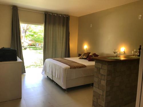 Ένα ή περισσότερα κρεβάτια σε δωμάτιο στο Pousada Beija-Flor