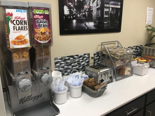 a counter with a food stand with food on it at Super 8 by Wyndham Bedford DFW Airport West in Bedford