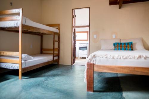 a bedroom with two bunk beds and a mirror at Casa Bougainvilla in Jericoacoara