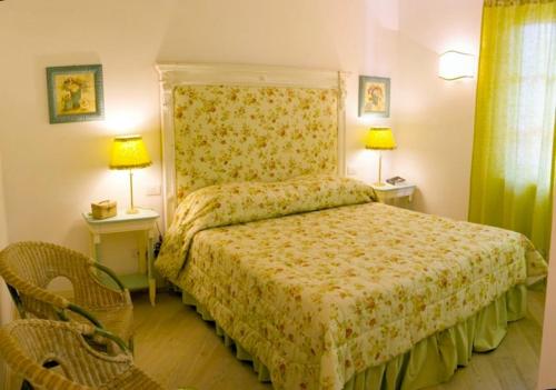 フォルテ・デイ・マルミにあるCasina Rosaのベッドルーム1室(ベッド1台、テーブル2台、ランプ2つ付)