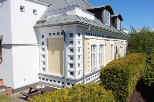 a large white building with a tin roof at Sunrise majutus in Pärnu