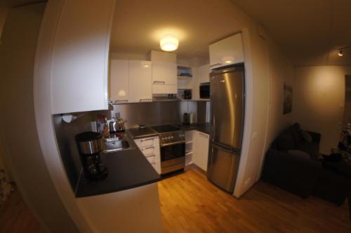 a small kitchen with a stainless steel refrigerator at Sarastus in Tornio