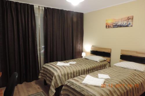 a hotel room with two beds and a window at The Best Location Accommodation in Bucharest
