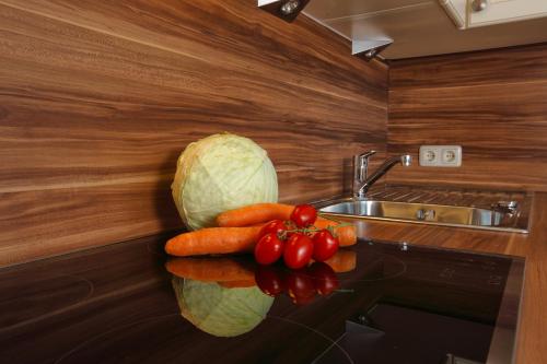 a pile of vegetables on a counter in a kitchen at Landhaus Erich in Sölden