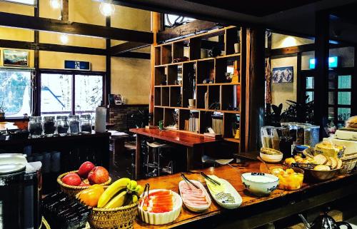 a kitchen with baskets of fruit on a table at B&B Santana Hakuba in Hakuba