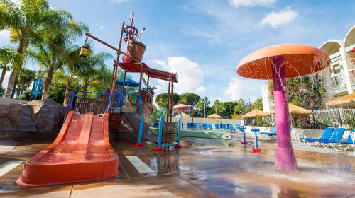 a playground at a resort with a slide and slidesktop at Howard Johnson by Wyndham Anaheim Hotel & Water Playground in Anaheim