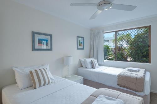Ένα ή περισσότερα κρεβάτια σε δωμάτιο στο Munna Beach Apartments