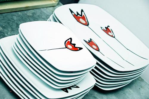 a stack of white plates on a table at Monkey Safari Hostel in Querétaro